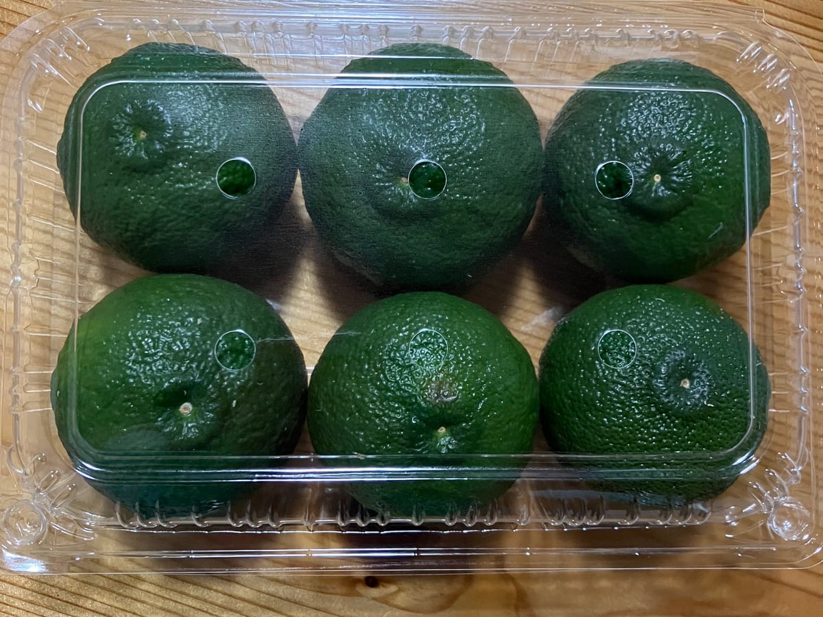 Green Yuzu packed six to a clear tray, ready for shipment.
